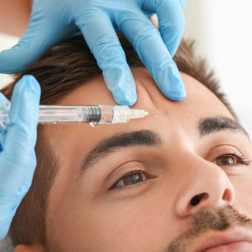 Male having Botox treatment to forehead