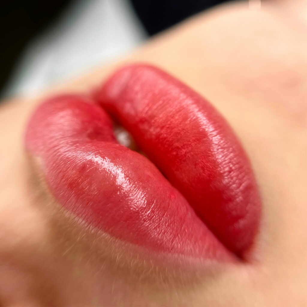 Plump red lips after Lip Blush treatment at Sympli Beauty in Winchester